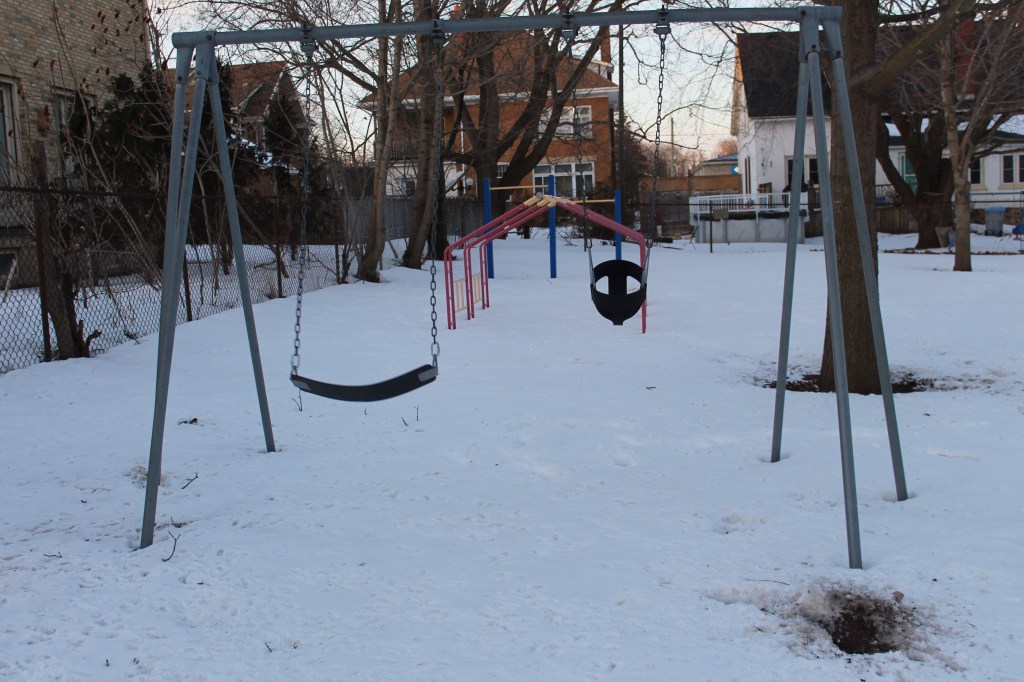 A photo of an empty playground in winter.